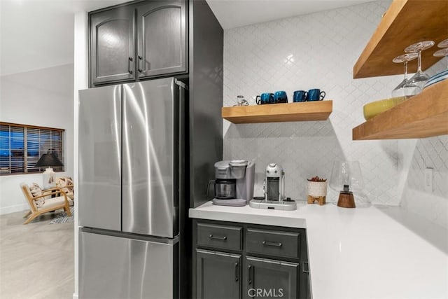 kitchen featuring tasteful backsplash and stainless steel refrigerator