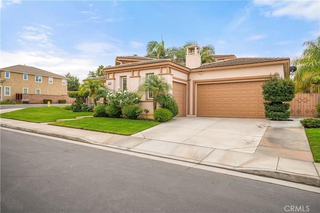 view of front of home featuring a front yard and a garage