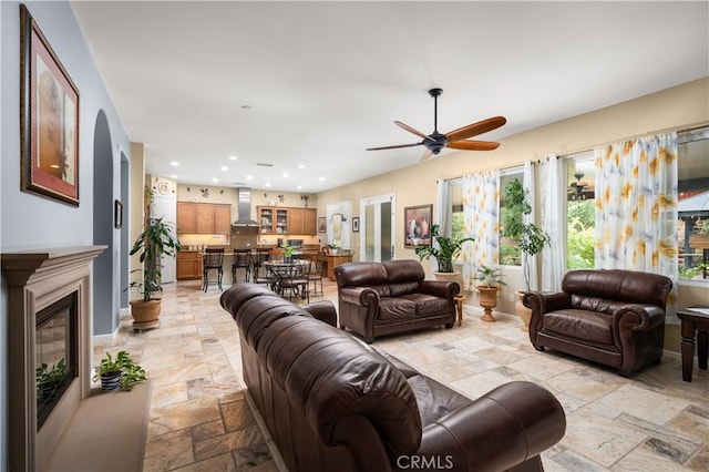 living room with ceiling fan and a wealth of natural light