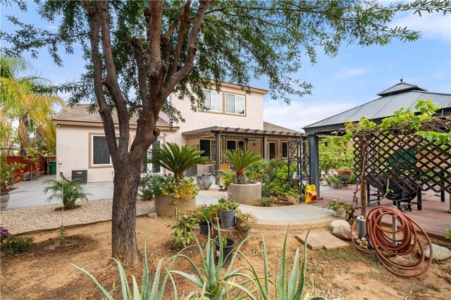 back of house featuring a gazebo and a patio