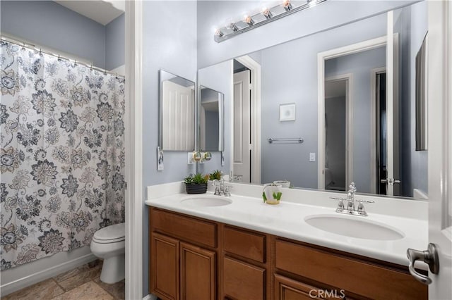 full bathroom with shower / tub combo with curtain, vanity, and toilet