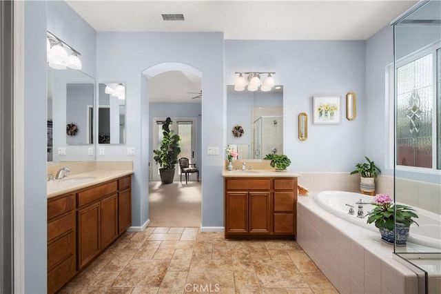 bathroom with vanity, separate shower and tub, plenty of natural light, and ceiling fan