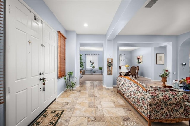 foyer entrance with an inviting chandelier