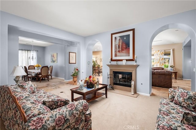 living room featuring light carpet and a chandelier