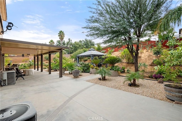 view of patio / terrace featuring a gazebo, ceiling fan, and central AC unit