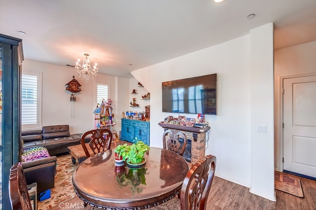 dining area featuring a chandelier, plenty of natural light, and hardwood / wood-style floors