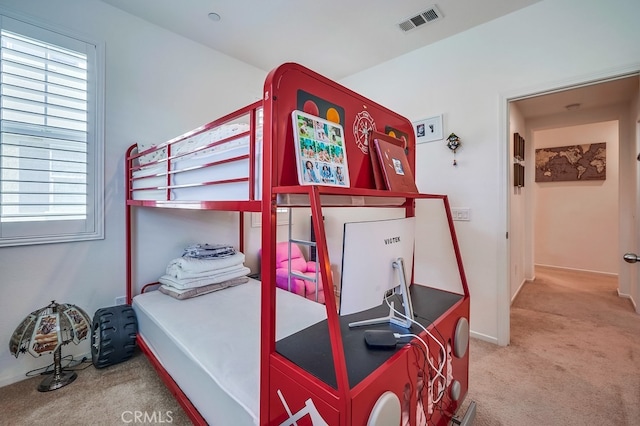 bedroom featuring multiple windows and carpet