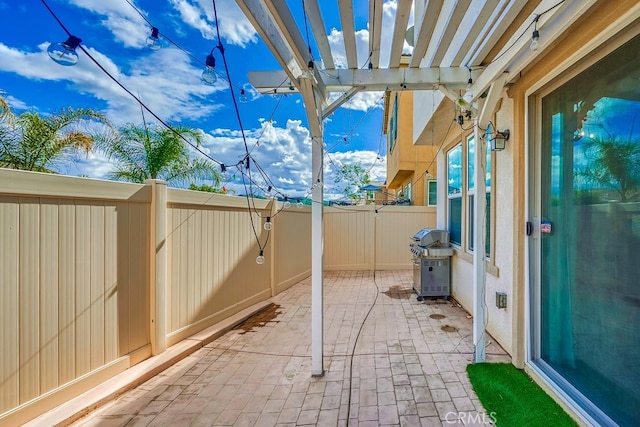 view of patio featuring area for grilling and a pergola