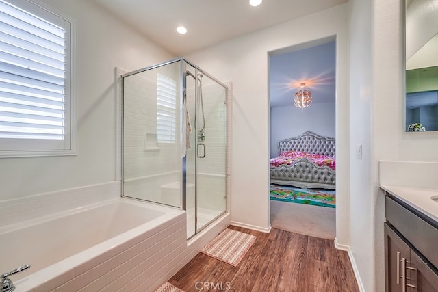 bathroom with vanity, shower with separate bathtub, and wood-type flooring