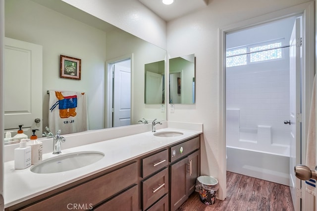 bathroom with vanity, shower / washtub combination, and hardwood / wood-style floors