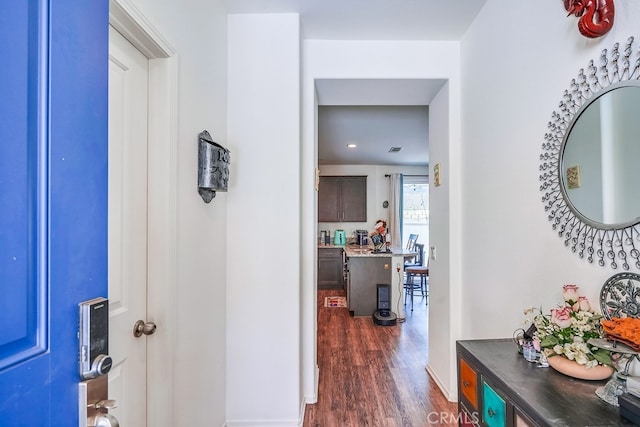 hallway with dark hardwood / wood-style flooring