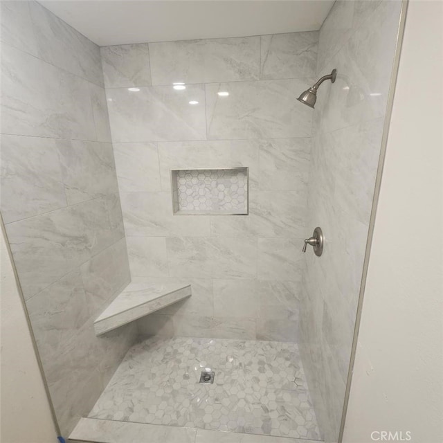 full bath featuring a tile shower