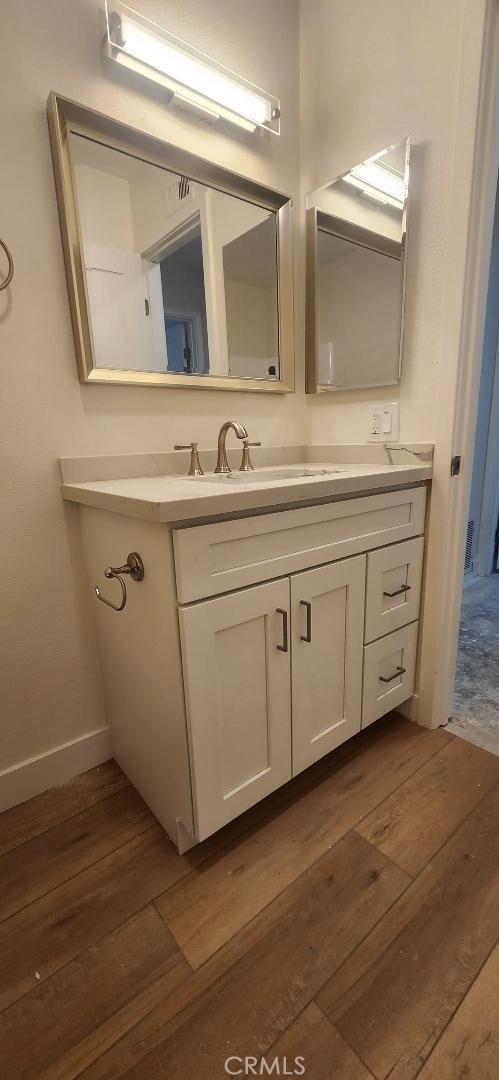 2511 W Sunflower Ave Unit P6, Santa Ana, CA 92704 - bathroom featuring vanity, hardwood / wood-style flooring, and baseboards