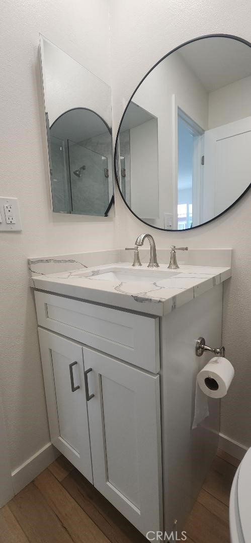2511 W Sunflower Ave Unit P6, Santa Ana, CA 92704 - bathroom with toilet, baseboards, vanity, and wood finished floors
