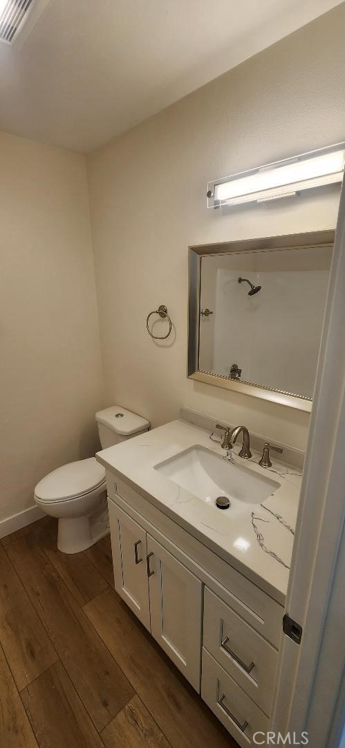 2511 W Sunflower Ave Unit P6, Santa Ana, CA 92704 - bathroom with visible vents, toilet, vanity, and wood finished floors