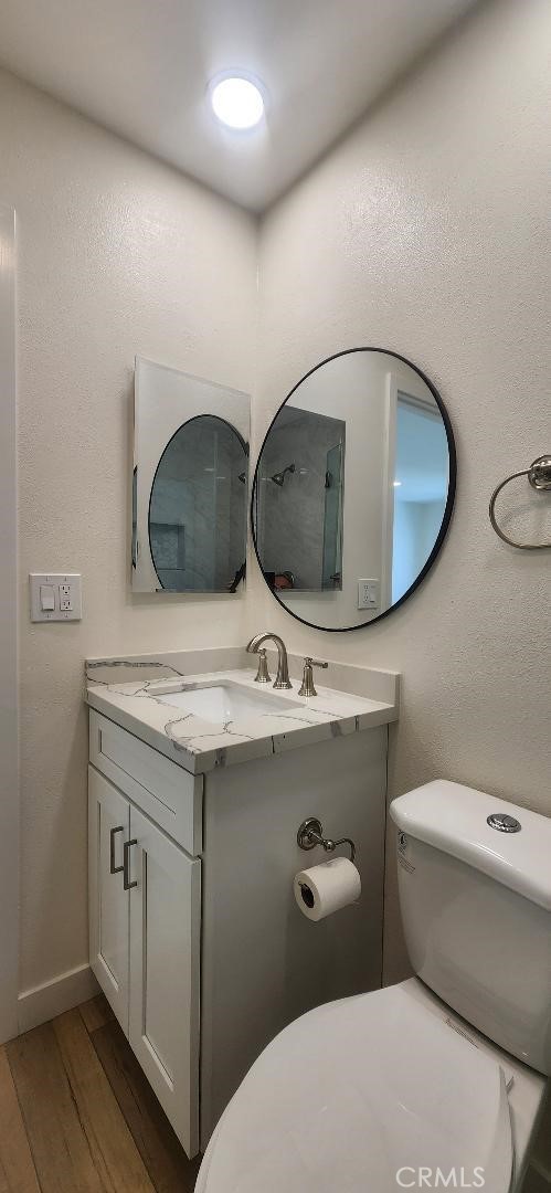 2511 W Sunflower Ave Unit P6, Santa Ana, CA 92704 - bathroom featuring vanity, toilet, and wood finished floors