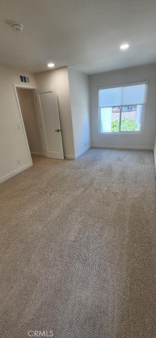 2511 W Sunflower Ave Unit P6, Santa Ana, CA 92704 - empty room with light carpet, visible vents, and baseboards