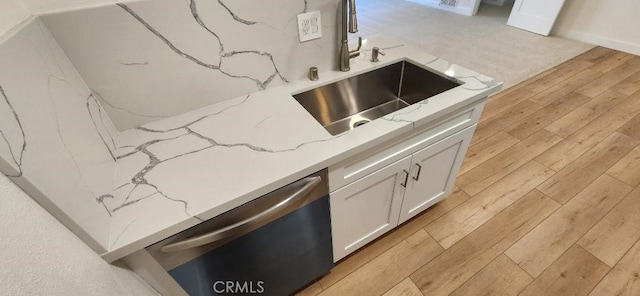 2511 W Sunflower Ave Unit P6, Santa Ana, CA 92704 - room details with white cabinets, light stone counters, dishwasher, a sink, and light wood finished floors