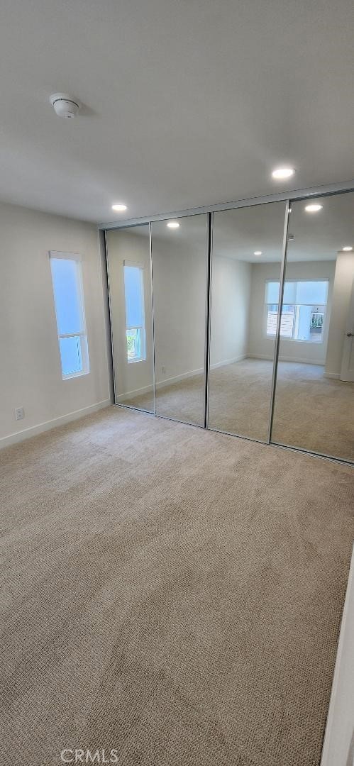 2511 W Sunflower Ave Unit P6, Santa Ana, CA 92704 - unfurnished bedroom with multiple windows, baseboards, and carpet floors