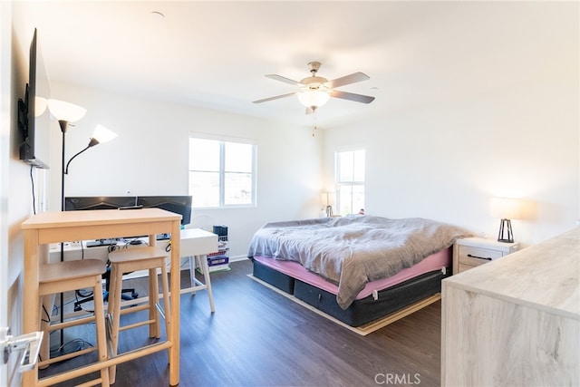 bedroom with dark hardwood / wood-style floors and ceiling fan