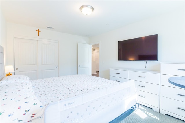 carpeted bedroom with a closet