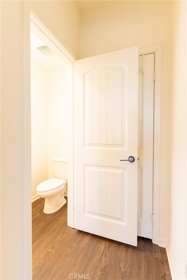 bathroom featuring toilet and hardwood / wood-style floors