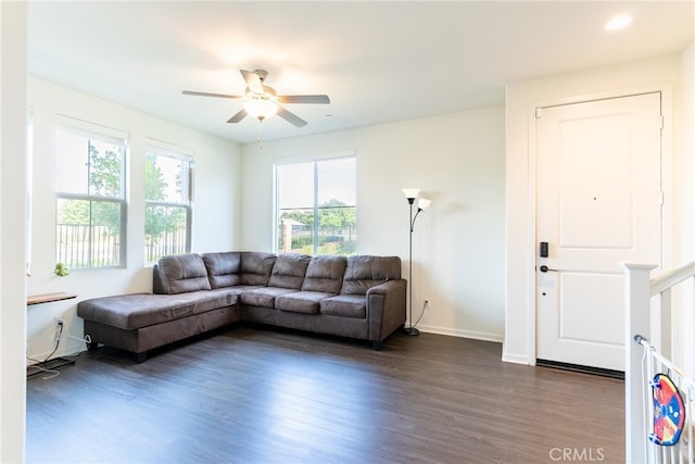 living room with dark hardwood / wood-style floors, plenty of natural light, and ceiling fan