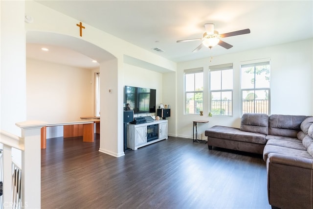 living room with ceiling fan and dark hardwood / wood-style floors