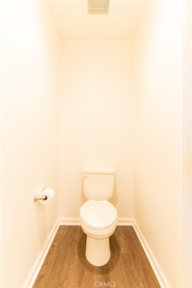 bathroom featuring wood-type flooring and toilet