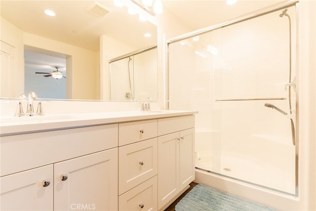 bathroom featuring vanity, ceiling fan, and walk in shower