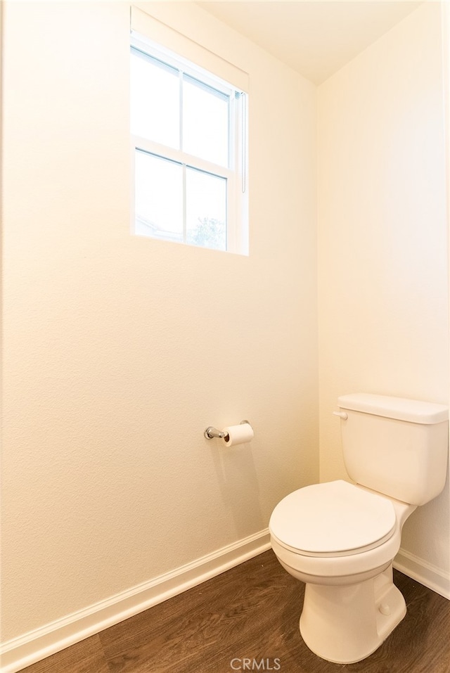 bathroom with toilet and hardwood / wood-style flooring