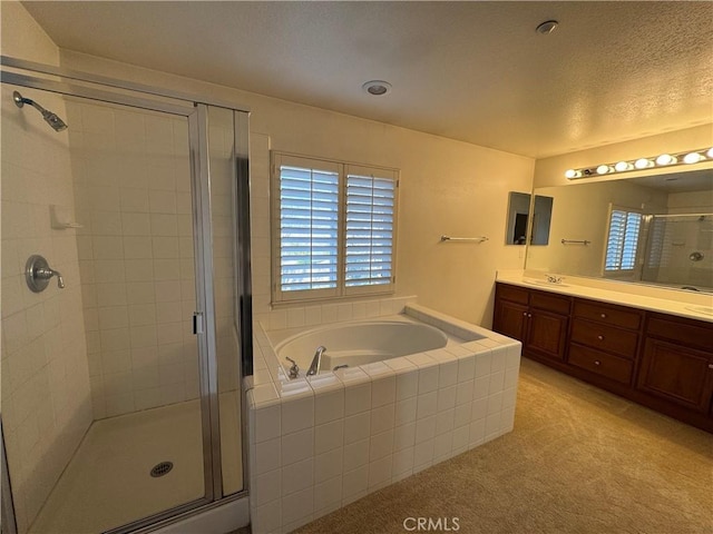 bathroom featuring vanity, separate shower and tub, and a healthy amount of sunlight