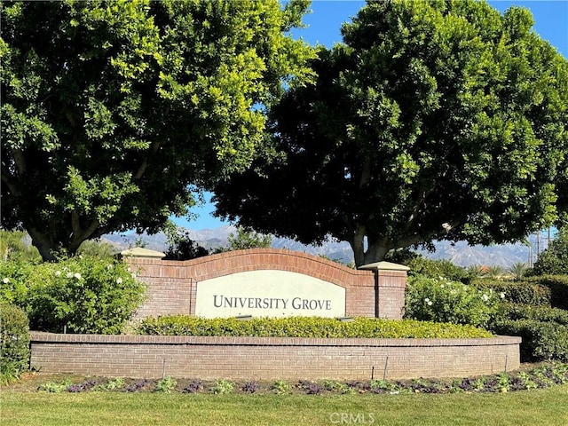 community sign with a mountain view