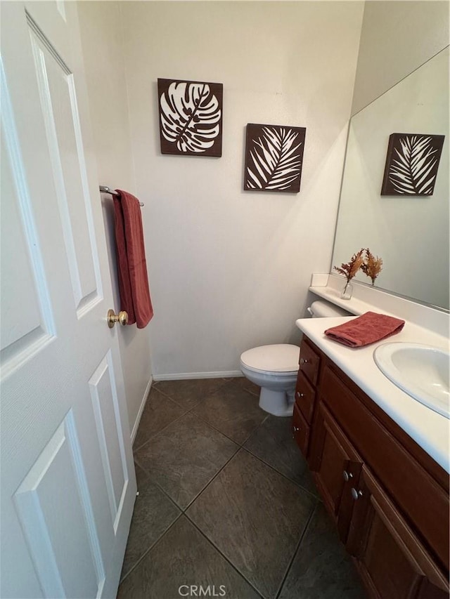 bathroom with vanity, toilet, and tile patterned flooring