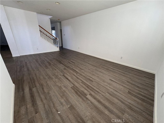 unfurnished living room with dark wood-type flooring