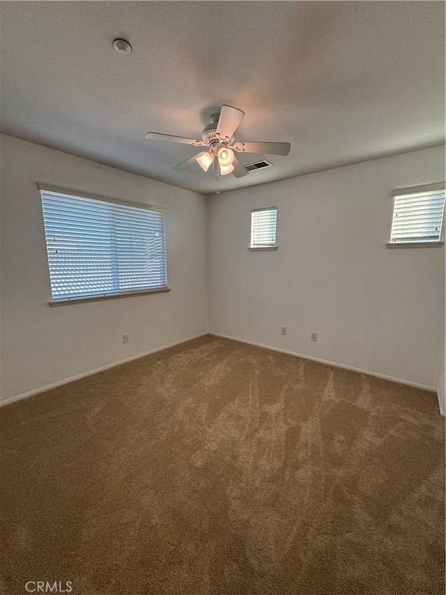 spare room with carpet floors and ceiling fan