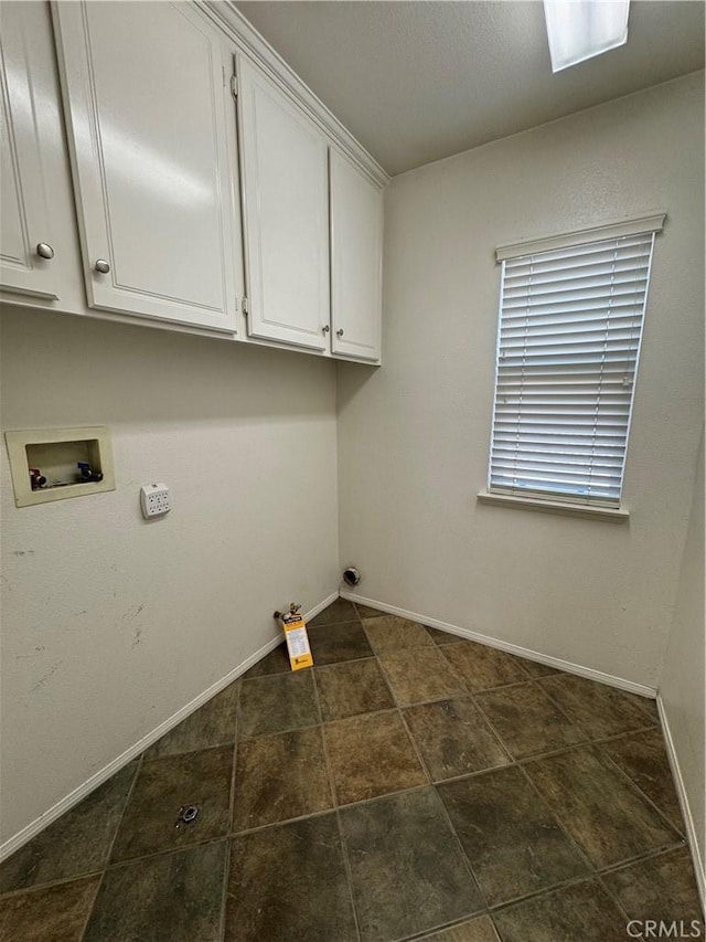 washroom with cabinets, washer hookup, and hookup for a gas dryer