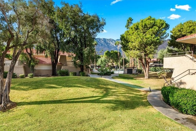 view of community with a mountain view and a yard