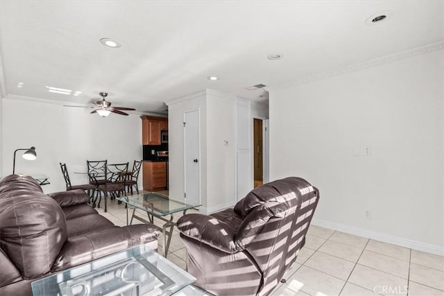 living room with ceiling fan, light tile patterned flooring, and ornamental molding