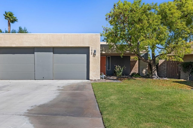 view of front of house featuring a garage and a front lawn