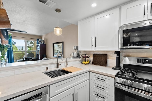 kitchen with sink, appliances with stainless steel finishes, and white cabinets