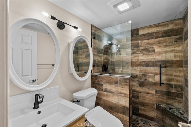 bathroom featuring vanity, toilet, and walk in shower