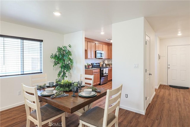 dining space with dark wood-type flooring