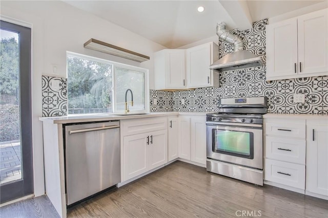 kitchen with white cabinetry, appliances with stainless steel finishes, light countertops, and a sink