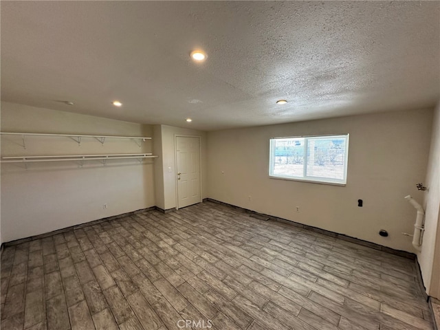 unfurnished bedroom featuring a closet, light hardwood / wood-style floors, and a textured ceiling