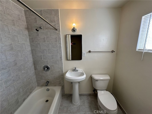 bathroom featuring toilet and tiled shower / bath combo