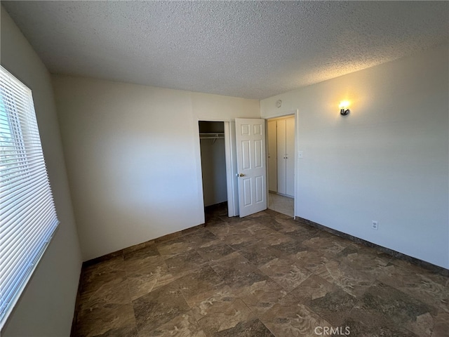 unfurnished bedroom featuring a closet and a textured ceiling