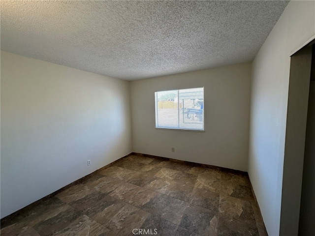 empty room with a textured ceiling