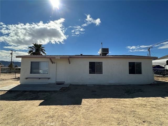 rear view of property featuring cooling unit