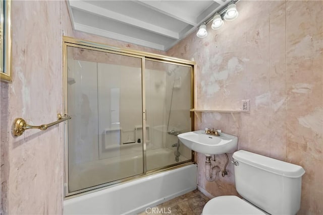 full bathroom featuring shower / bath combination with glass door, toilet, and sink